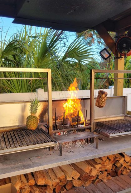 asado grill by poolside tiki bar