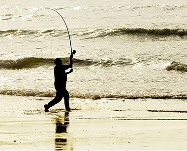 man fishing on shore