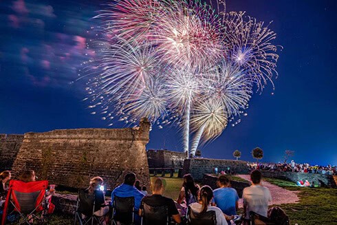 fireworks over Castillo de san marcos with audience watching in lawn chairs